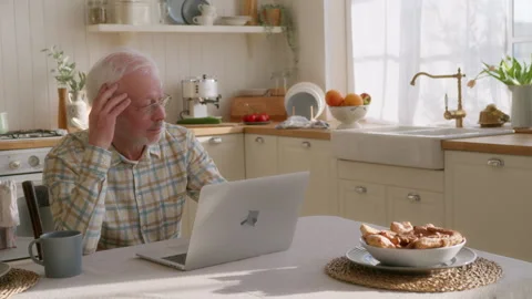 Elderly man uses laptop Stock Footage 264305802