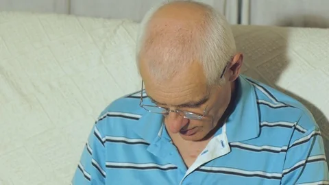 Elderly man uses tablet Stock Footage 76535356