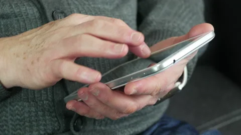 Elderly man uses a tablet Stock Footage 234293104