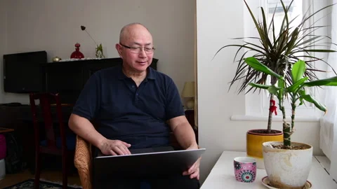 Elderly man using a laptop at home. Stock Footage 234614779