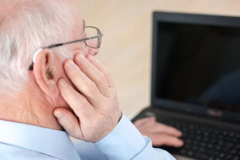 Elderly man using laptop Stock Photos
