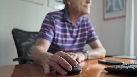 Elderly Man Using Mouse And Staring At Computer Screen With Focused Look While S Stock Footage 321403113