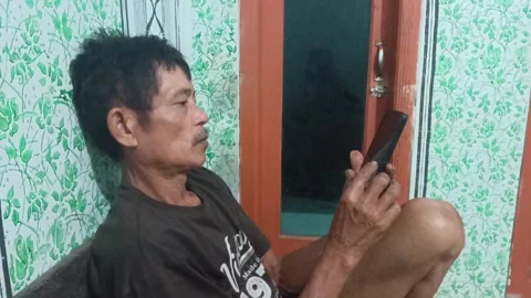 Elderly man using smartphone at home Stock Footage 316993275