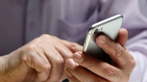 Elderly Man Using Smartphone While Sitting At The Table Stock Footage 72957149