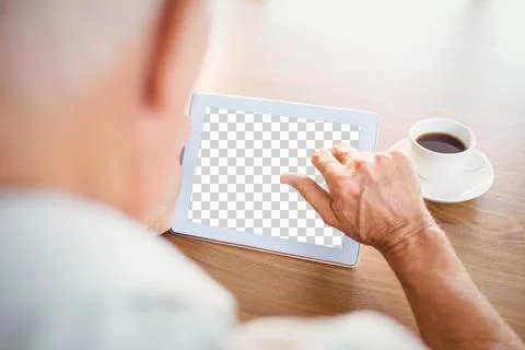 Elderly man using tablet and drinking coffee Stock Photos