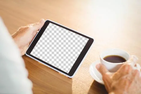 Elderly man using tablet and drinking coffee Stock Photos