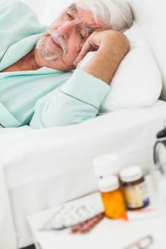 Elderly man waking up Stock Photos
