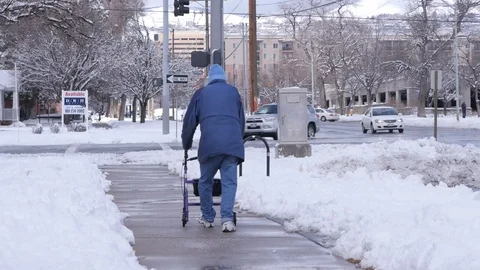 Elderly Man With Walker In Snow walks passed Stock Footage 86750845