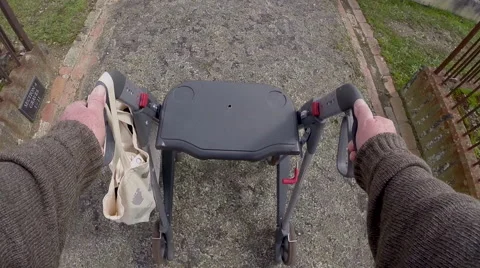 Elderly man with walking frame visits cemetery Stock Footage 55489840