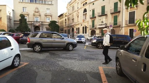 An elderly man walking on the medieval streets of Palma de Mallorca, Spain Stock Footage 83628985