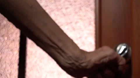 An Elderly Man's Hand Opens the Door to the Light Room Stock Footage 156936149
