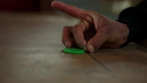 Elderly man's hand poised over a carrom board in a mountain village Vídeos de archivo 342398211