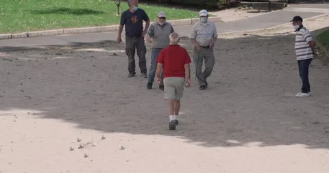 Elderly men are playing a typical French game of ball outdoor, end of Stock Footage 131961132