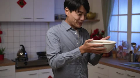 Elderly mother serving freshly cooked food Stock Footage 166074992