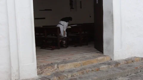 Elderly nun inside Cali's oldest church called La Merced Stock-Footage 88481703