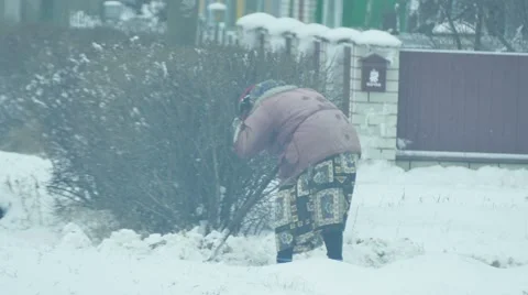 Elderly old woman cleans snow pale winter Stock Footage 59171337