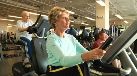Elderly people on cardio machines Stock Footage