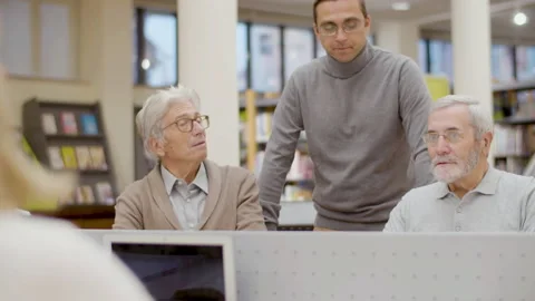 Elderly people studying in library with young teacher Stock-Footage 232622018