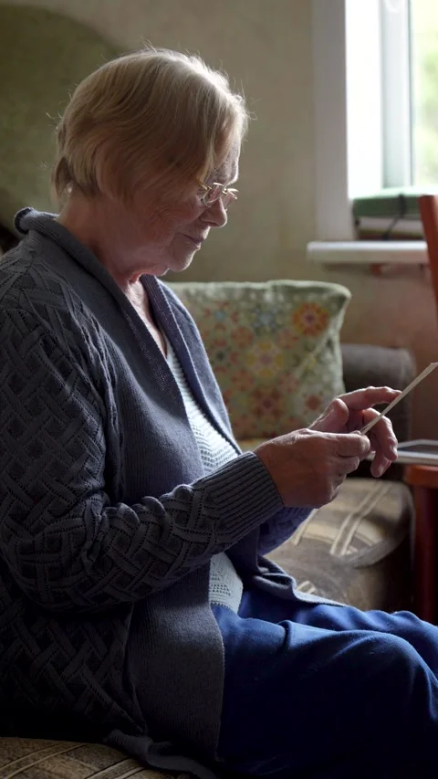 Elderly person browsing old black white photos reminiscing about past Video stock 313791704