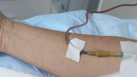 Elderly person hands shaking during blood transfusion, emergency help, illness Stock Footage 119299034