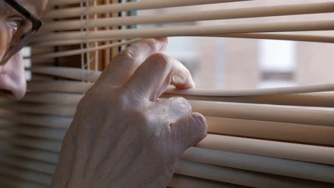 Elderly Person Looking Through Window Blinds From Inside Home, Close-Up of Hand Stock Footage 318123427
