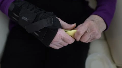 Elderly Person Practicing Hand Exercises With Colorful Playdough at Home Stock Footage 295390748