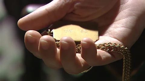 The elderly person's hand, slightly open, holding the nameplate Video stock 276516925