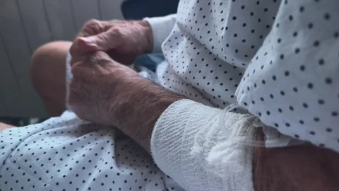 Elderly person's shaking and fidgeting hands while checking into the hospital. Stockbeeldmateriaal 342587749