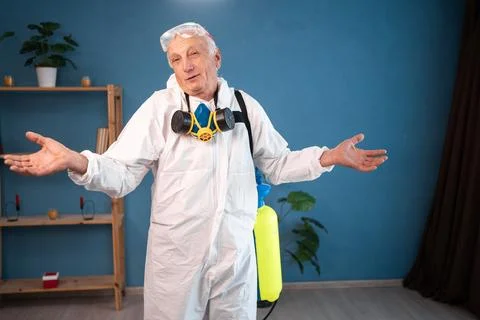 Elderly pest control worker killing insects say I don't know raised arms and  Stock Photos
