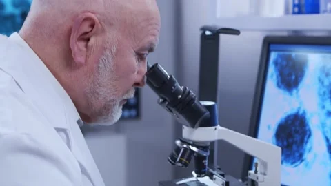 Elderly professor is doing a science experiment in a modern laboratory. Genetic Stock Footage 149699112