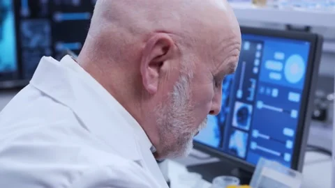 Elderly professor is doing a science experiment in a modern laboratory. Genetic Stock Footage 149919249