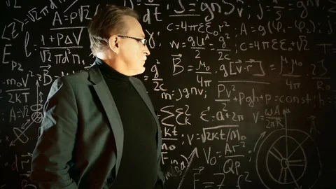 Elderly professor giving a lecture, mathematical formula on blackboard Stock Footage 128927210