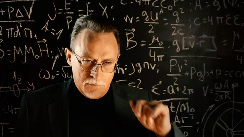 Elderly professor giving a lecture, mathematical formula on blackboard Stock Footage 129042750