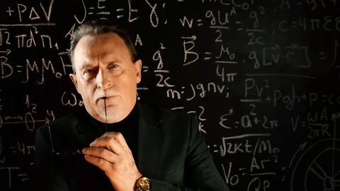 Elderly professor giving a lecture, mathematical formula on blackboard Stock Footage 129043367