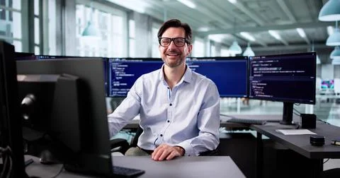 Elderly Programmer Smiling While Writing Code For Web Development Project. Stock Photos