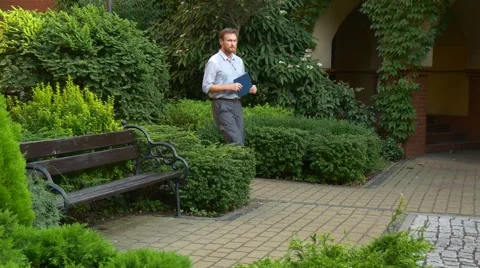 An Elderly Red-Haired Man Goes on Avenue Stock Footage 67554324
