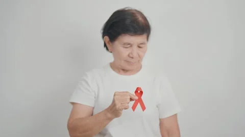 Elderly with Red Ribbon for December World Aids Day, MADD, October Red ribb.. 스톡 동영상 316827341
