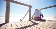 Elderly Retired Couple Sitting Together Affectionately At The Beach Stock Footage