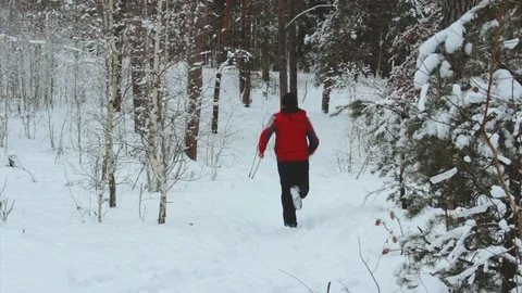 Elderly running man through a snowy forest Stock Footage 100445847