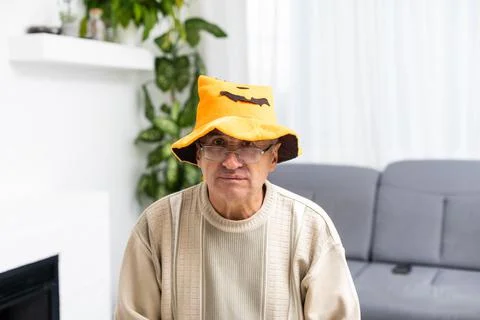 Elderly sad man celebrating halloween at home. Stock Photos