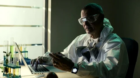 Elderly scientist use smart watch to check status of order in online shop at his Stock Footage 72121847