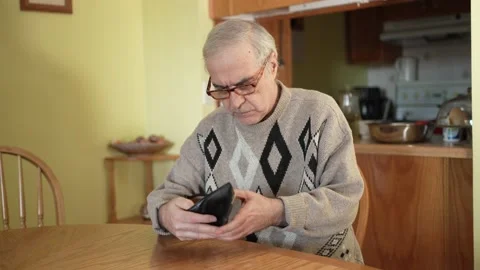 Elderly senior Men Looking at Empty Wallet Without Money Stock Footage 164688099