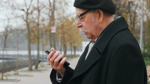 Elderly senior using smart phone voice recognition, dictates thoughts, voice Stock Footage 143728541