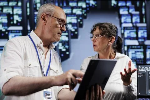 Elderly servicemen doing server analysis Stock Photos