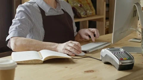 Elderly Shop Owner Typing on Computer Видео 71968790
