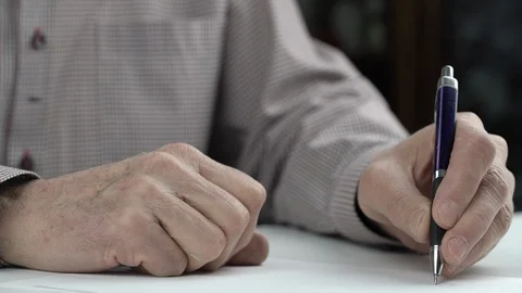 Elderly sick man learns to write letter with left hand Видео 124401141