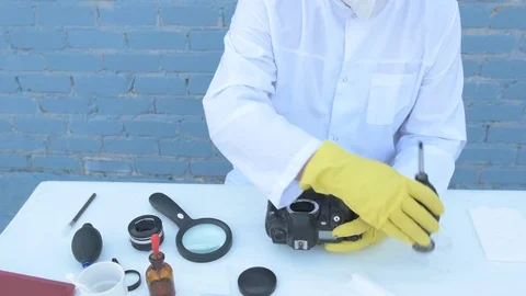 Elderly solid person in white dressing gown, cap, medical mask, glasses clean Stock Footage 93428821