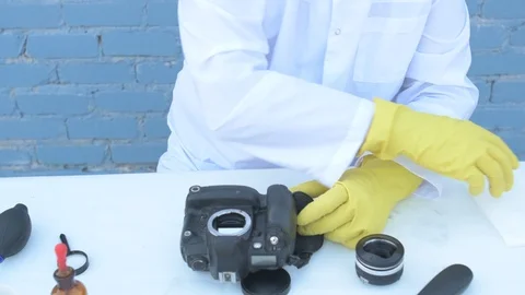 Elderly solid person in white dressing gown, cap, medical mask, glasses clean Stock Footage 93429076