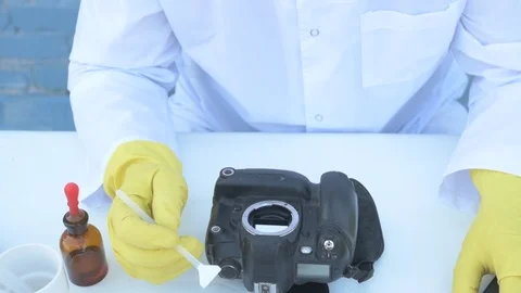 Elderly solid person in white dressing gown, cap, medical mask, glasses clean Stock Footage 93429157