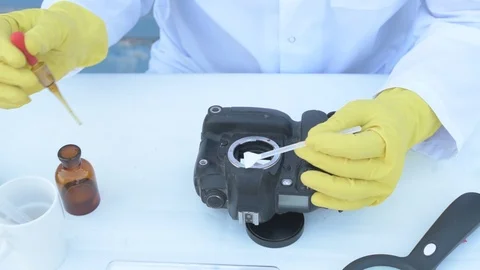 Elderly solid person in white dressing gown, cap, medical mask, glasses clean Stock Footage 93429211